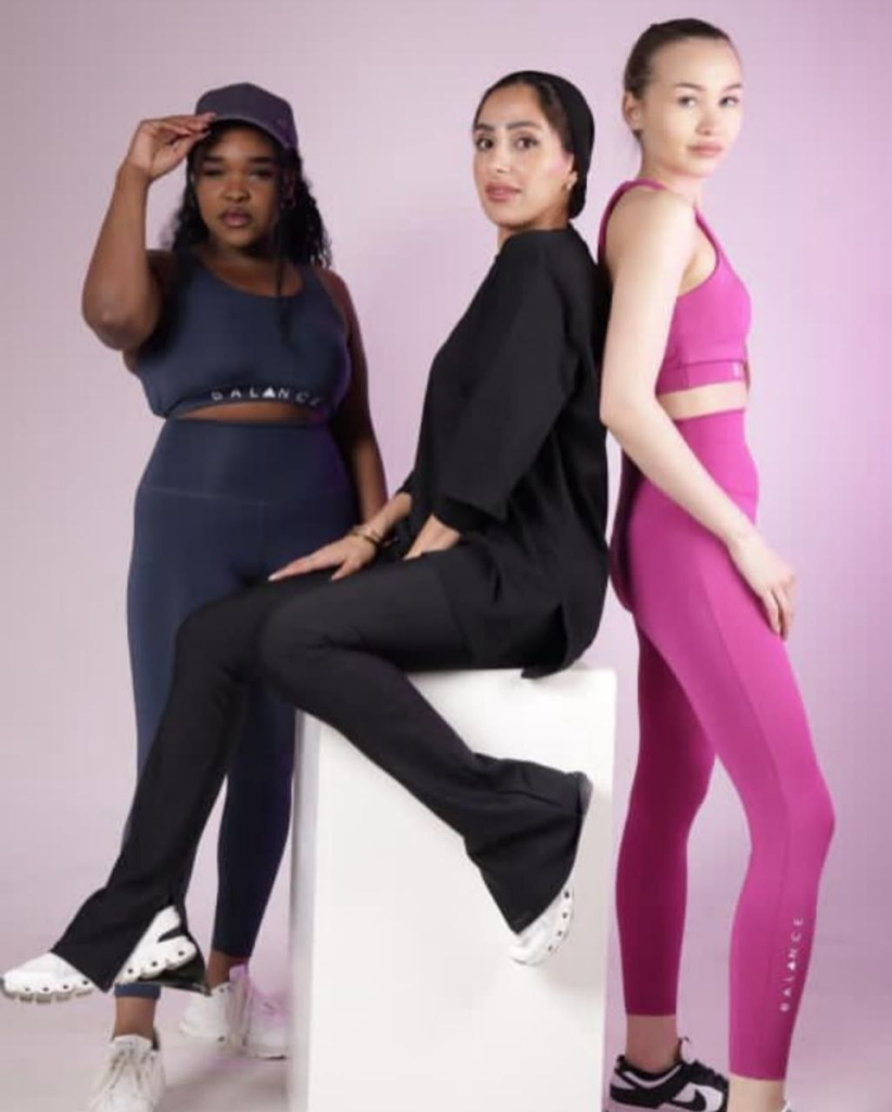 Three women wearing BALANCE gear - navy blue, black and fuchsia